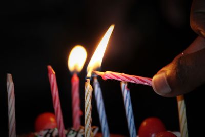 Close-up of hand holding candle