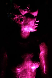 Close-up of pink flower over black background