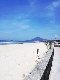 Scenic view of beach against blue sky