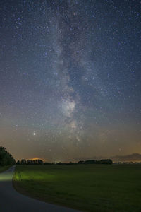 View of milky way over a field