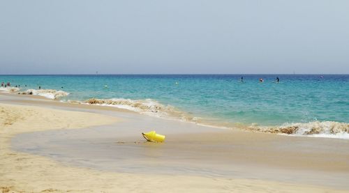 Scenic view of beach against clear sky