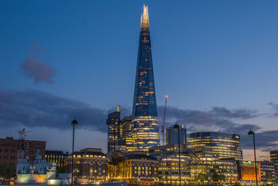 Low angle view of illuminated buildings against sky