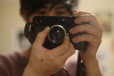 Cropped image of woman photographing through smart phone