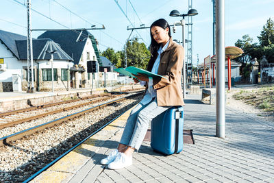 Woman standing on railroad station platform