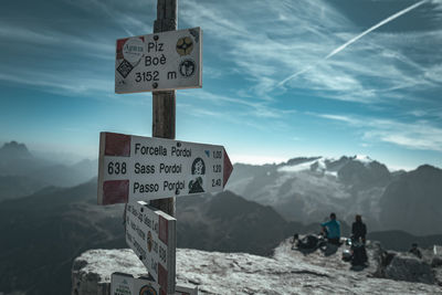 Low angle view of road sign against sky