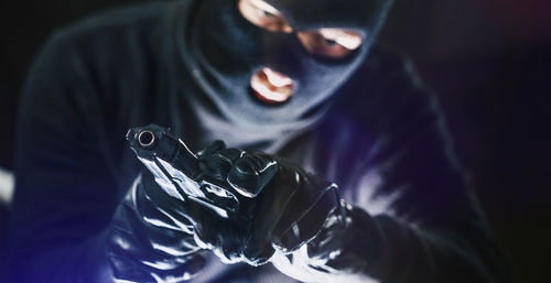 Portrait of burglar holding gun