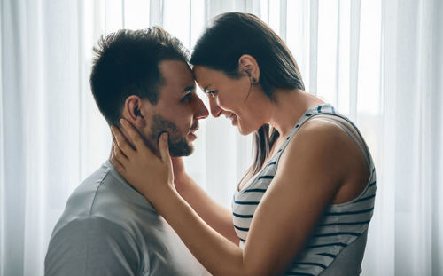 Side view of young couple at home