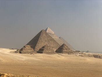 Scenic view of desert against clear sky pyramids of giza cairo egypt 