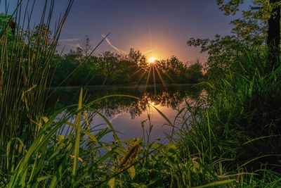 Scenic view of lake against sky during sunset