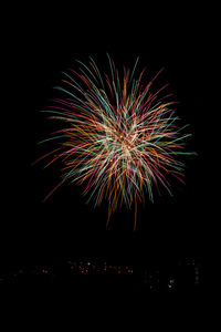 Low angle view of firework display against sky at night
