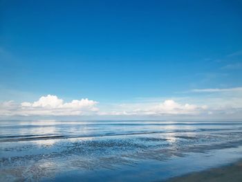 Scenic view of sea against blue sky
