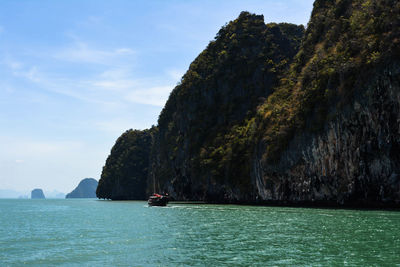 Scenic view of rocks in sea against sky