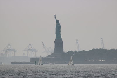 Statue of liberty against sky during sunny day