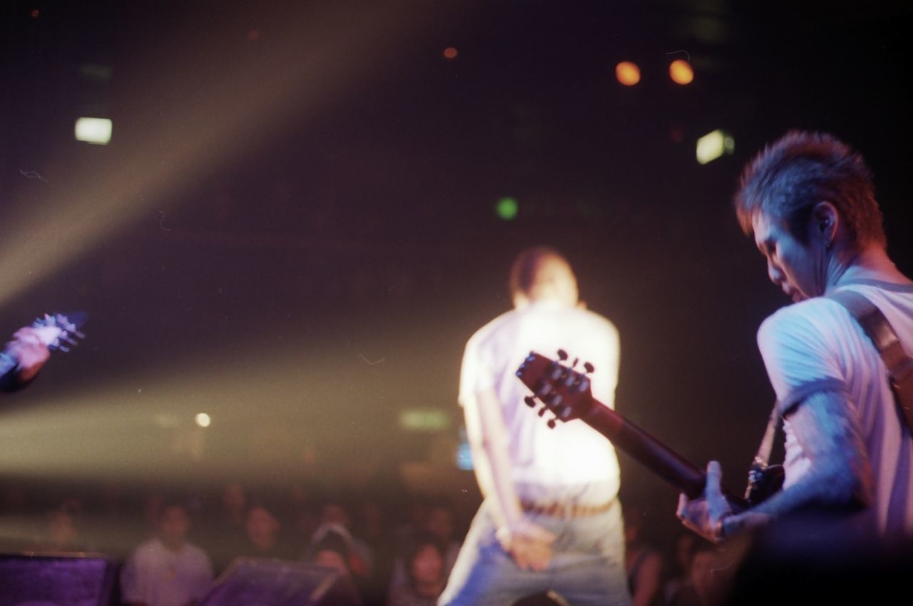 illuminated, night, lifestyles, leisure activity, arts culture and entertainment, men, performance, music, enjoyment, person, motion, nightlife, event, skill, fun, blurred motion, holding, indoors