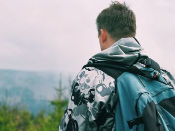 Rear view of man against sky