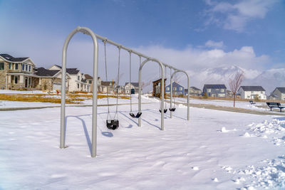 View of swing in snow covered field