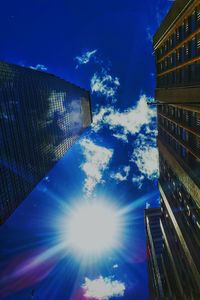 Low angle view of modern building against blue sky