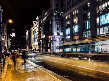 Blurred motion of illuminated street and buildings at night