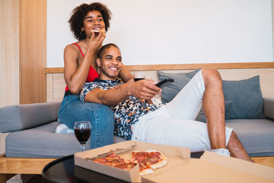 Happy women sitting on sofa