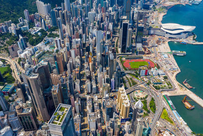 Aerial view of city by sea against sky