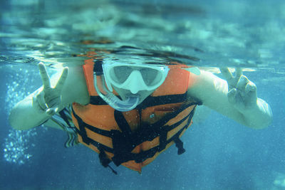 Close-up portrait of man swimming underwater