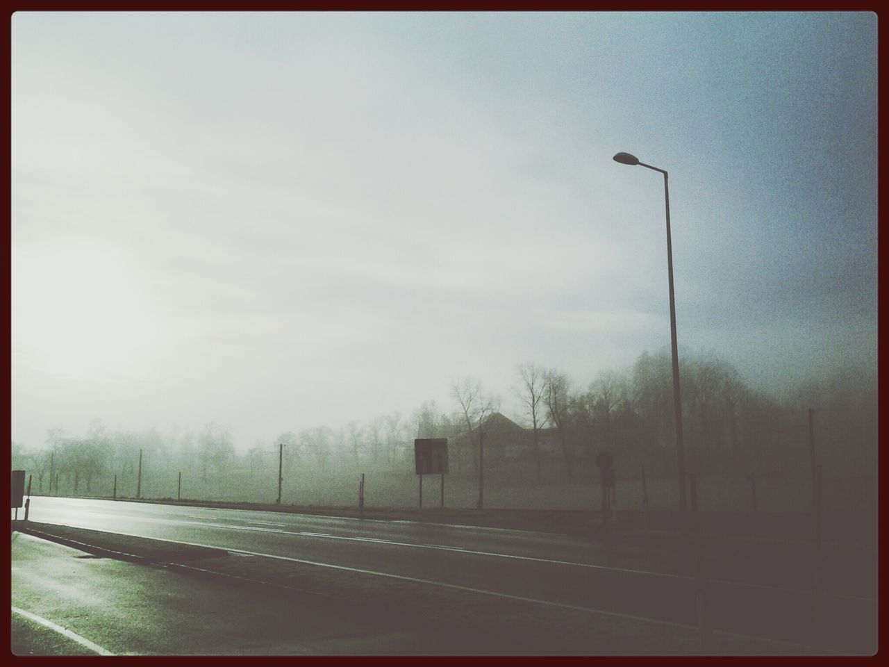 transfer print, auto post production filter, transportation, sky, road, tree, the way forward, street light, road marking, street, outdoors, diminishing perspective, nature, no people, empty, day, railroad track, cloud - sky, tranquility, clear sky