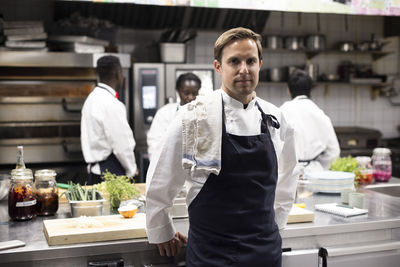 Portrait of confident chef standing in restaurant kitchen