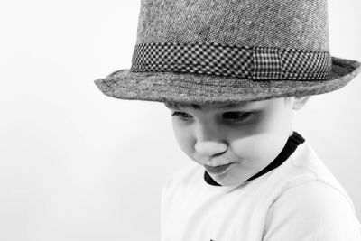 Portrait of boy wearing hat against white background