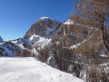 Scenic view of snowcapped mountains against clear blue sky