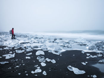 Hiker on beach in winter