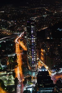 Aerial view of city lit up at night