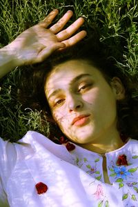 Portrait of woman lying down on plant