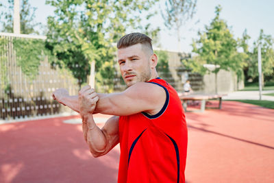 Side view of young man exercising at park