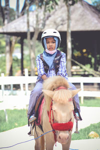 Portrait of girl riding horse