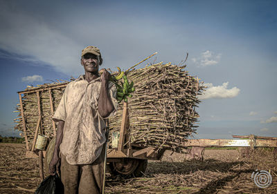 Man working on field against sky