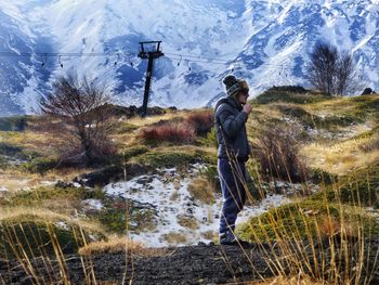 Full length of man standing on snow covered land