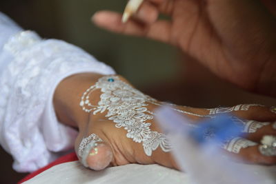 Beautiful and unique henna art in the hands of indonesian brides, selective focus	
