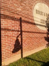 Shadow of person on brick wall