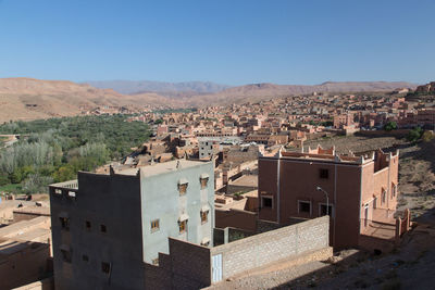 Residential buildings against clear blue sky