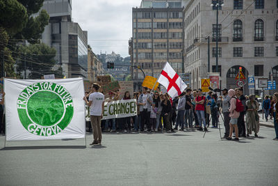 Group of people walking on street in city