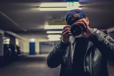 Man photographing while standing in parking lot