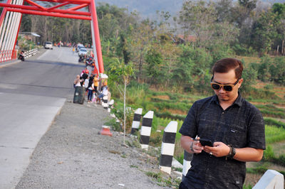 Young man using mobile phone in park