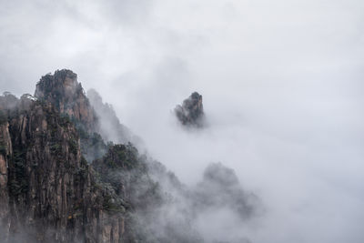 Scenic view of waterfall against sky