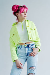 Young woman standing against white background