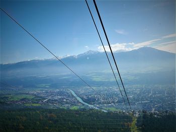 Low angle view of overhead cable car against sky