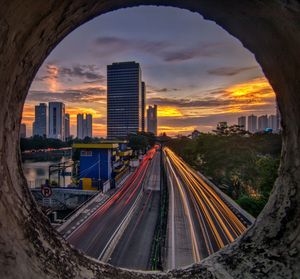 High angle view of road and buildings against sky during sunset