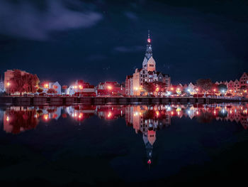 Reflection of illuminated buildings in water at night