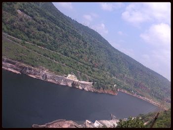 Scenic view of mountains against cloudy sky