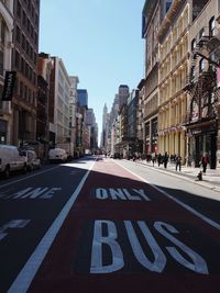 City street and buildings against sky