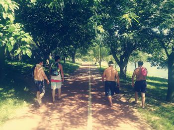 Rear view of people walking on footpath